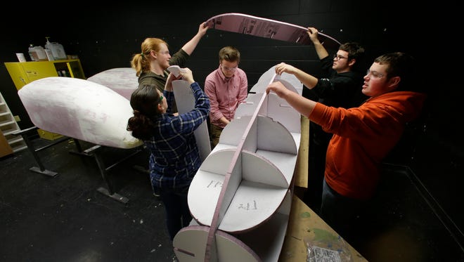 Students collaborate to put together a foam skeleton for a super mileage vehicle at Kimberly High School. They strip it out like a wooden canoe, then apply fiberglass to create the body of the vehicle.