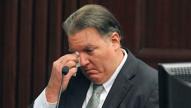 Michael Dunn wipes a tear as he testifies during his retrial at the Duval County Courthouse on Tuesday, Sept. 30, 2014, in Jacksonville, Fla. Dunn is being retried on murder charges for the shooting death of 17-year old Jordan Davis in a dispute over loud music at a Jacksonville gas station in November of 2012.