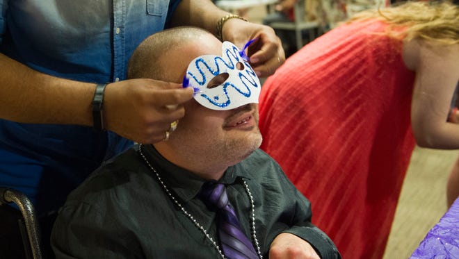 Robert Mathis tries his mask on for the first time at 2018 Circle K Special Education Prom held at the University of Evansville. The event's theme was a masquerade.
