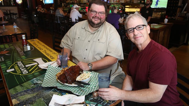 Oregon reporter Pete Martini, left, and Oregon State reporter Gary Horowitz at the Half Penny Bar & Grill.