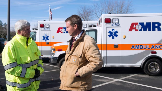 Knox County Mayor Tim Burchett, right, talks with Rural Metro Fire Chief Jerry Harnish during a news conference announcing the rebranding of Rural Metro ambulances to AMR on Thursday, Dec. 8, 2016.