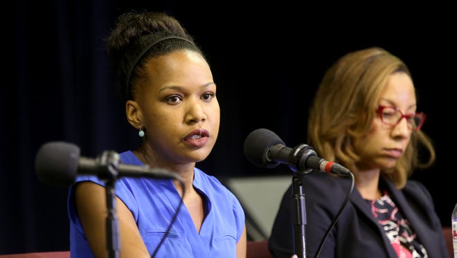 Ashley Harrington, Black Lives Matter Cincinnati Steering Committee member, makes a point during Thursday's panel discussion. At right is Rickell Howard, Ohio Director of Policy and Litigation, Cincinnati Children's Law Center.