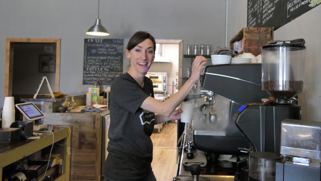 Megan Giorgetti prepares cappuccino at Brew 56 in Lyons, Kansas. The shop also sells alcohol.