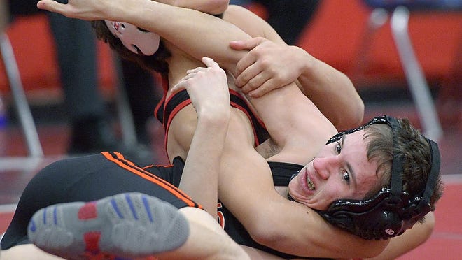 Hilton’s Greg Diakomihalis, top, beat Churchville-Chili’s Hunter Potts with a 19-4 technical fall in the 106-pound weight class during a meet at Hilton High School on Wednesday, Jan. 13, 2016.