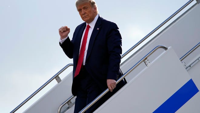 President Donald Trump gestures as he steps off Air Force One upon arrival at Minneapolis Saint Paul International Airport, Wednesday, Sept. 30, 2020, in Minneapolis.