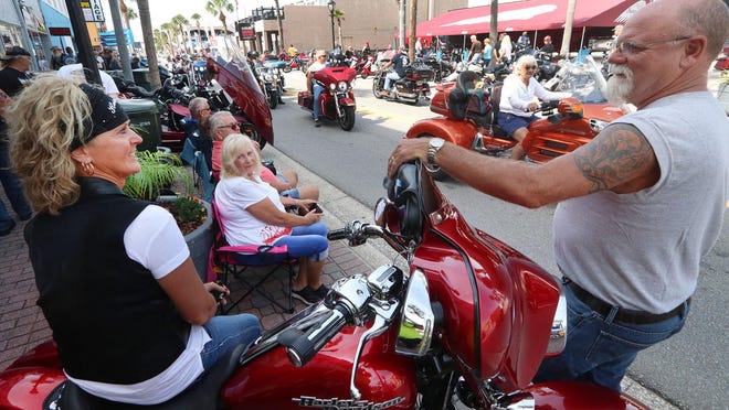 Biketoberfest visitors watch a parade of people and motorcycles on Main Street at last year's Biketoberfest in Daytona Beach.