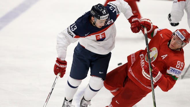 Slovakia's Tomas Jurco, left, collides with Belarus’ Dmitri Korobov during the Hockey World Championships Group B match in Ostrava, Czech Republic, Sunday, May 3, 2015.