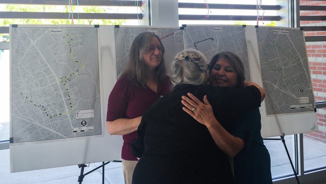 Shannon Kearns, center, hugs RoadRUNNER Transit employee Loretta Covarrubia while fellow bus employee Margret Hensley looks on earlier this week. Covarrubia and Hensley helped RoadRUNNER Transit bus driver Socorro Cabellero return $680 to Kearns that she lost on a city bus.