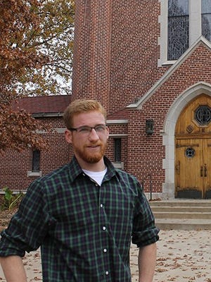 Duncan Tiemeyer, Student Government Association president at St. Gregory’s University near Shawnee, Okla., discusses his future plans. Behind him is the St. Gregory’s Abbey church where Benedictine Order monks pray multiple times daily.