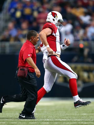 ST LOUIS, MO - DECEMBER 11:   Drew Stanton #5 of the Arizona Cardinals hobbles off the field after being sacked by Aaron Donald #99 of the St. Louis Rams in the third quarter during their game at Edward Jones Dome on December 11, 2014 in St Louis, Missouri.  (Photo by Dilip Vishwanat/Getty Images)