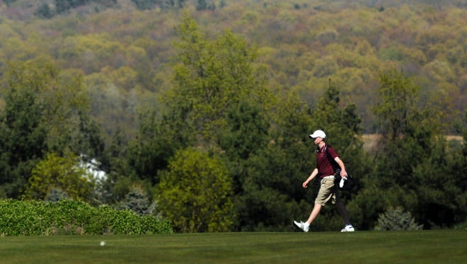 Cullen Spang walks The Links at Union Vale while playing golf for Arlington High School against Roy C. Ketcham on May 6, 2013.