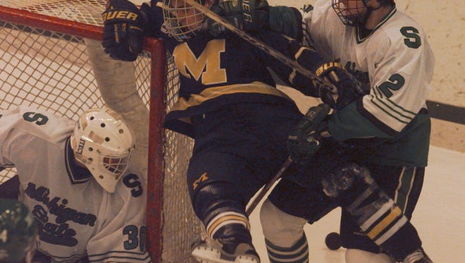 Michigan hockey player Scott Matzka plays against Michigan State in 1999.
