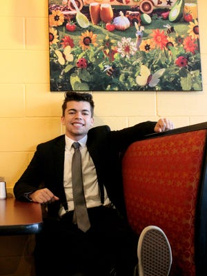 Timothy Parsley of Pensacola is seen in one of his senior photos, taken at the North Ninth Avenue location of Moe's Southwest Grill. The Mexican restaurant chain gave Parsely free burritos for his freshman year after learning of the photo session at his favorite restaurant.