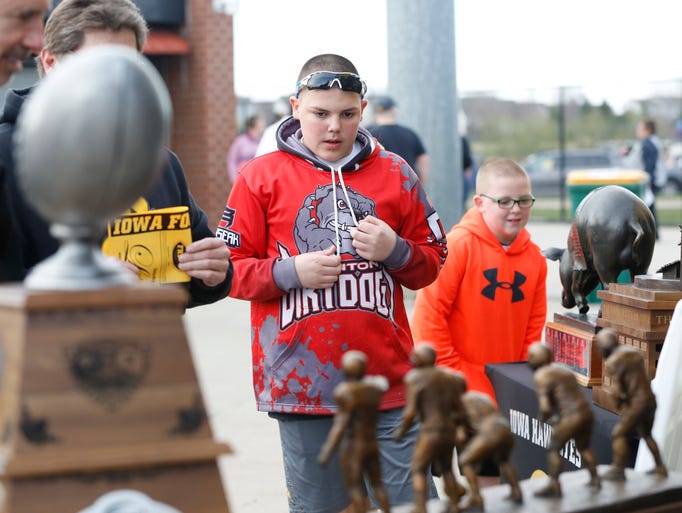 Young fans look over the rivalrly trophies on display