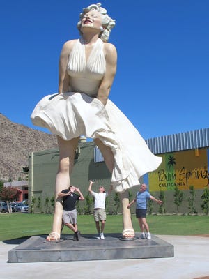 People pose with the "Forever Marilyn" statue in Palm Springs.