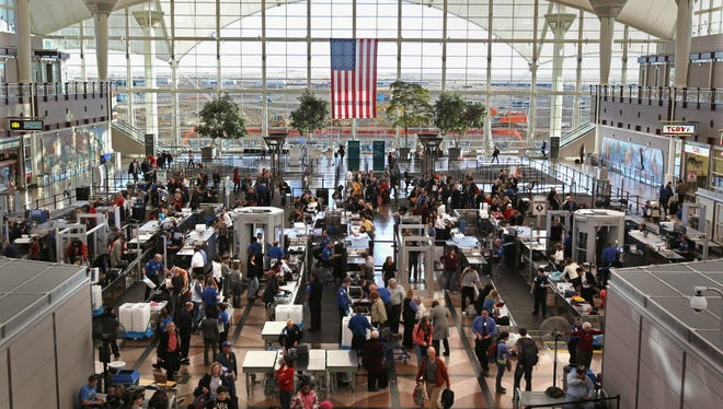 Passengers move through a main security checkpoint at the Denver International Airport on Nov. 22, 2010 in Denver, Colo.