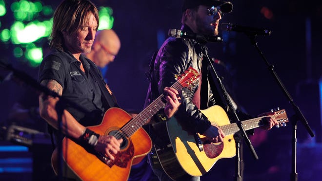 Keith Urban and Eric Church perform “Raise ‘Em Up,” which went to No. 1 on Billboard’s Country Airplay chart last week.