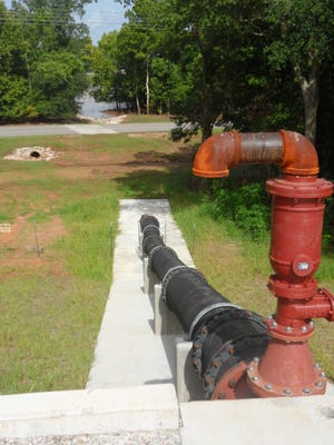 A sewer pipe from the Pineville sewer plant runs above ground over the Red River levee and toward the river (background). The pipe had to be relocated over the levee because federal regulations no longer allow it to run through the levee. The pipe relocation is  part of the levee recertification work being done in Rapides Parish.