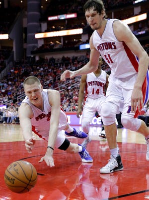 The Detroit Pistons' Henry Ellenson and Boban Marjanovic go after a loose ball on Friday night.