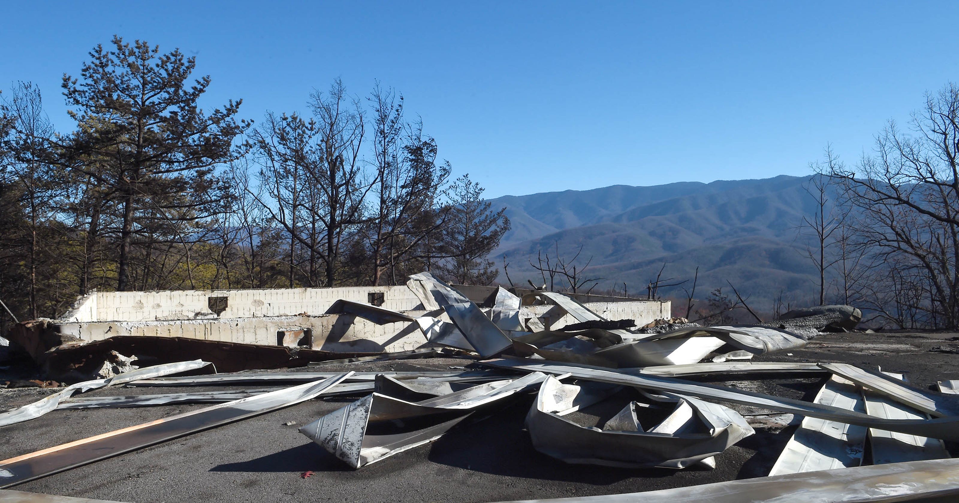 Manager shows burned Cobbly Nob homes