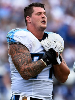 Titans tackle Taylor Lewan walks off the field in pain and supporting his shoulder after getting hurt in a game earlier this season.
