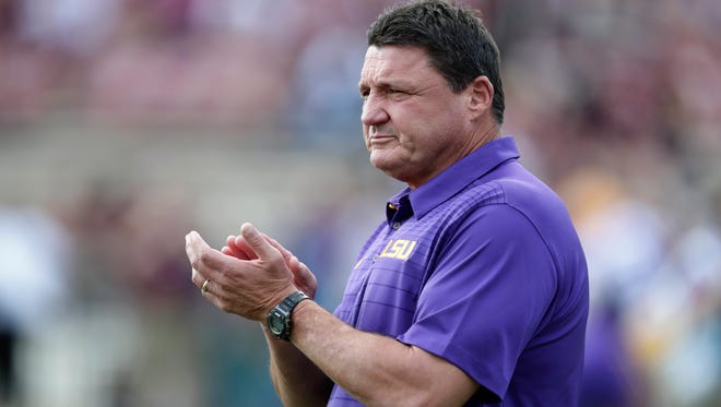 LSU head coach Ed Orgeron cheers his team during the pregame warm up drills prior to their NCAA college football game against Mississippi State in Starkville, Miss., Saturday, Sept. 16, 2017.