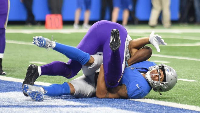 The Lions' Marvin Jones Jr. makes a touchdown catch despite tight coverage by the Vikings' Xavier Rhodes late in the second quarter.