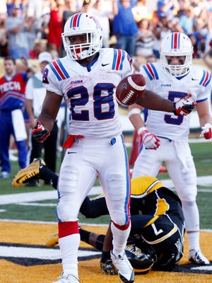 
Louisiana Tech running back Kenneth Dixon (28) scored three second-half touchdowns to lift the Bulldogs to a 31-20 win Saturday over Southern Miss.
