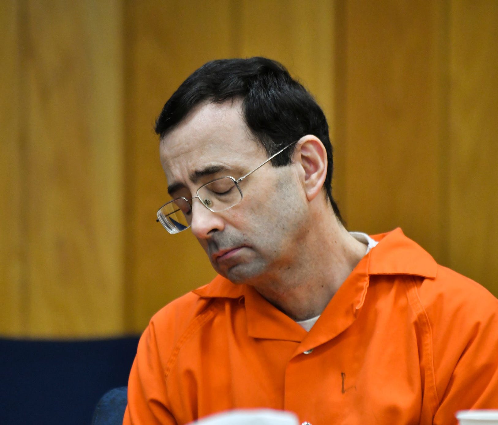 Larry Nassar hangs his head Wednesday, Jan. 31, 2018, during the first day of victim-impact statements in Eaton County (Mich.) Circuit Court in Charlotte, Mich., where Nassar is expected to be sentenced on three counts of sexual assault some time nex