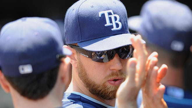 Tampa Bay Rays manager Ben Zobrist, right, and Matt Joyce high five before the start of a baseball game against Baltimore Orioles.