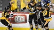 Penguins celebrate their four goal during the third