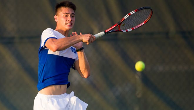 Memorial's Brandon Wu returns a shot during his match against Castle's Evan Bottorff during the Bosse boys tennis regional at North High School in Evansville, Wednesday, Oct. 5, 2016.