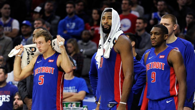 The Detroit Pistons' Luke Kennard, Andre Drummond and Langston Galloway watch the final minutes of the second half from the bench during Saturday night's loss to the Philadelphia 76ers.