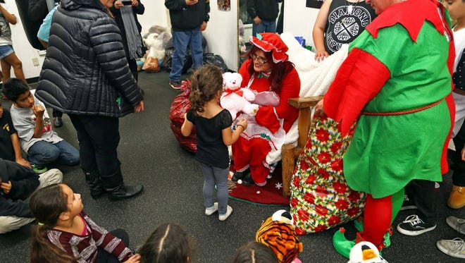 Debbie Aguilar, founder of A Time for Grieving and Healing, gives out presents at a past "Christmas in the Park."