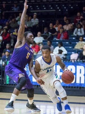 UWF men's basketball's Rashaan Benson (11) drives past Jamaar Taylor (5) during a recent game against Montevallo. Weather and travel concerns caused UWF to reschedule its weekend home schedule to Friday and Sunday games.