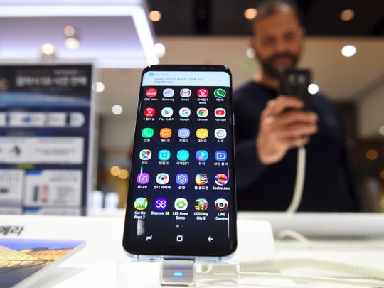 A visitor tests Samsung's Galaxy S8 at a Samsung showroom in Seoul on April 7, 2017.