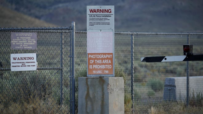 Signs warn about trespassing at an entrance to the Nevada Test and Training Range near Area 51 outside of Rachel, Nev.
