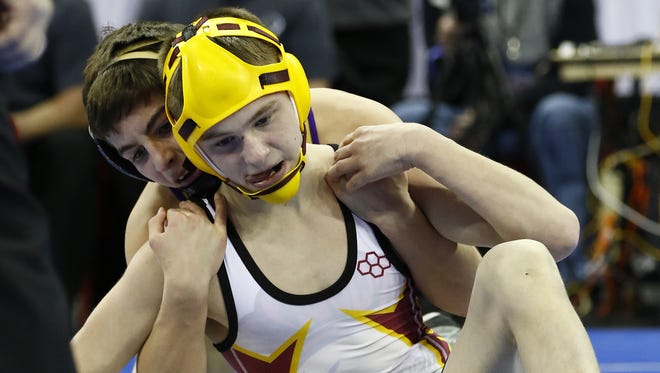 Luxemburg-Casco freshman Bryce Bosman, front, wrestles with Two Rivers freshman Joey Bianchi during the 106-pound WIAA Division 2 state match Saturday at the Kohl Center in Madison.