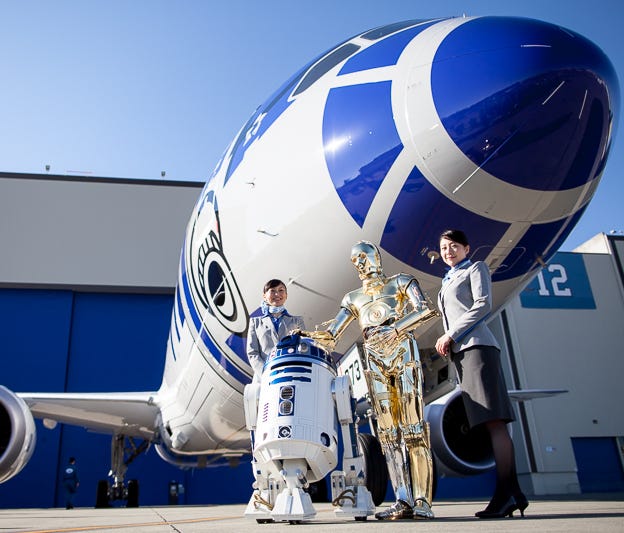 Star Wars characters R2-D2 and C-3P0 pose with  All Nippon Airways' R2-D2, Star Wars-themed Boeing 787-9 at a ceremony in Everett, Wash., on Sept. 12, 2015