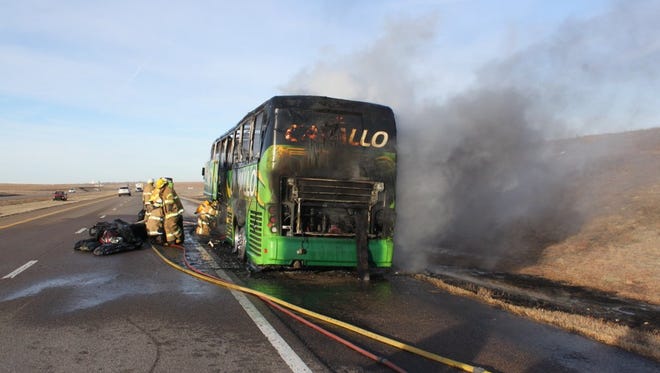 Firefighters put out flames on a charter bus carrying Purdue students on I-70 in Kansas.