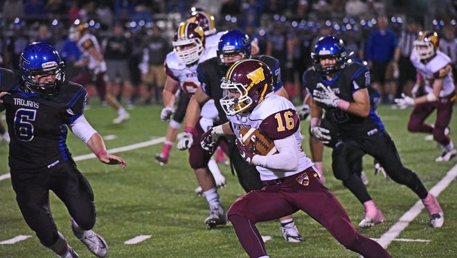 Windsor's Landon Schmidt evades Longmont defenders at Everly-Montgomery Stadium on Oct. 15. The Wizards and Trojans will meet in the 4A semifinals Saturday in Longmont.