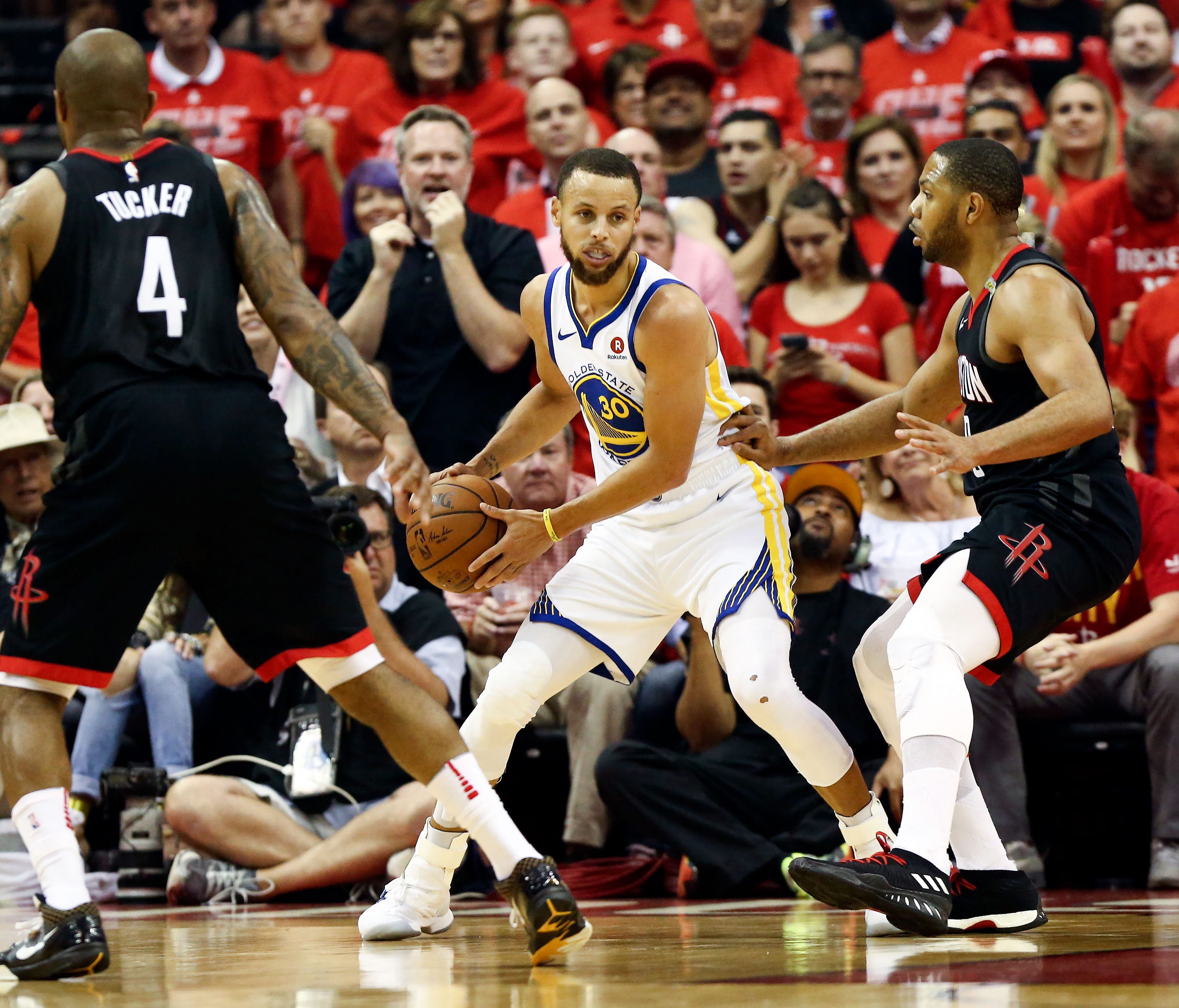 Golden State Warriors guard Stephen Curry (30) dribbles the ball in between Houston Rockets forward PJ Tucker (4) and guard Eric Gordon (10) during the first quarter in game seven of the Western conference finals of the 2018 NBA Playoffs at Toyota Ce