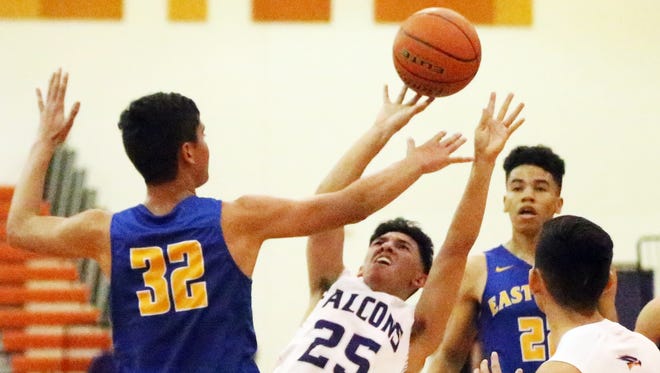 Alex Pina, 25, of Eastlake takes an off balance shot while driving to the basket against Diego Hernandez, 32, of Eastwood Tuesday night. Eastlake prevailed 66-62.