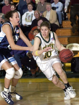 Maine's Abby Schrader shadows UVM's Dawn Cressman as she dribbles towards the basket during a game at Patrick Gym.