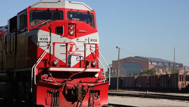 A locomotive from the Indiana Rail Road Co. is shown at the Senate Avenue Terminal with Lucas Oil Stadium in Downtown Indianapolis in the background.