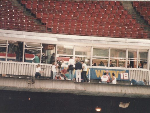 Bob Uecker is filmed inside the broadcast booth at