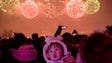 People watch a fireworks display as they visit an ice