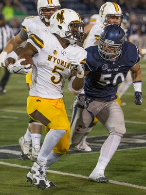 Nevada's Austin Paulhus tries to track down Wyoming's Brian Hill last Saturday. Paulhus was one of four healthy linebackers left on Nevada's roster by the end of the game.