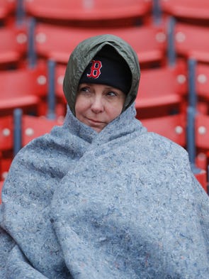 A Red Sox fan bundles up before the start of the game