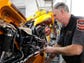 Dean Colegrove, a 30-year veteran mechanic, works on